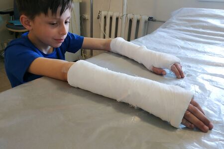 A little boy after a closed fracture approached the hospital for medical assistance in the form of an overlay of plaster bandage 2020の写真素材
