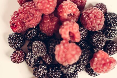 The composition of fragrant and delicious black and red raspberries on a white background are isolated in the studio. 2019の写真素材