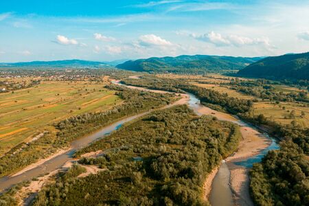 Rural landscape in the low mountains of the Western Carpathians, visible mountain river and fields. 2019の写真素材