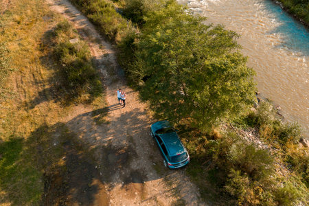GOSHOV, UKRAINE - AUGUST 1, 2019, A car stands near the river bank in a field.