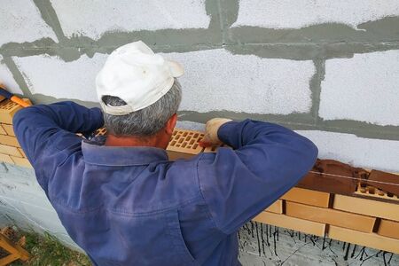 The master builds a wall from the front brick in the village. 2019の写真素材