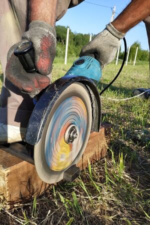Closeup of a metal profile with an angle grinder. 2019