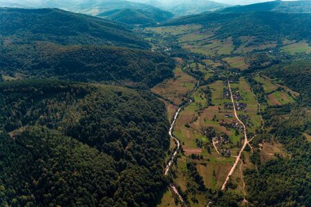 Aerial drone view of mountain, pine forest, river and village, Carpathian, Ukraine 2019の写真素材
