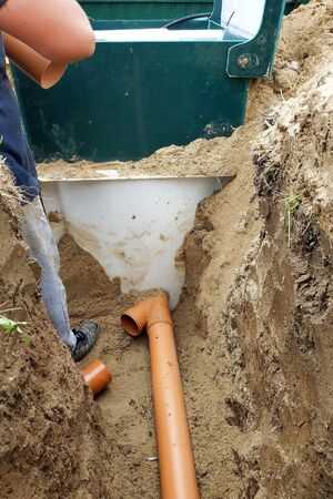 Supply of a sewer pipe to a sump by a master locksmith in the countryside. 2019の写真素材