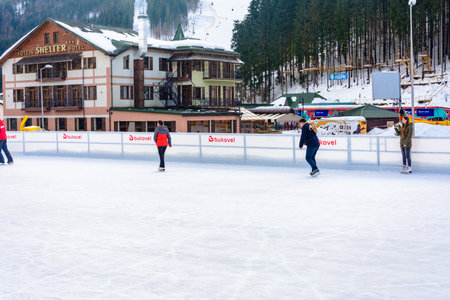 Bukovel, Ukraine February 12, 2019 - a man in a dark jacket skates for the first time. 2019のeditorial素材