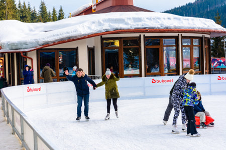 Bukovel, Ukraine February 12, 2019 - young couple roller skating for the first time. 2019のeditorial素材