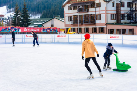 Bukovel, Ukraine February 12, 2019 - little girl roller skates with adults.のeditorial素材