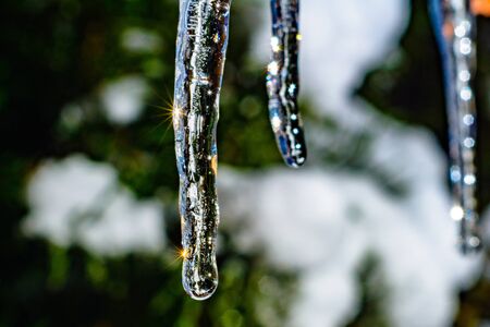 Frozen icicle on the edge of the roof of the house close up cold frosty winter. 2019の写真素材