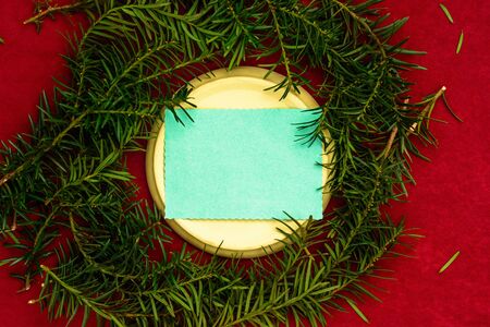 Christmas tree branches stacked in a circle for the inscription Merry Christmas on a red background. 20119の写真素材
