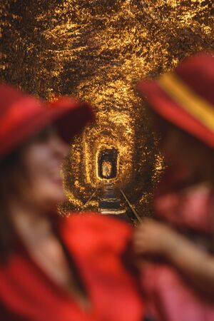 Mom with daughter in red hats walking in autumn in tunnel of love. 2019の写真素材