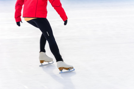 Bukovel, Ukraine February 12, 2019 - girl in a red jacket ice skating instructor in Bukovel. 2019のeditorial素材