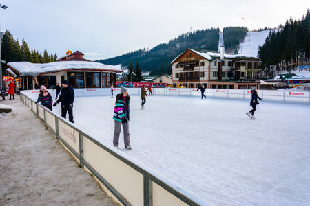 Bukovel, Ukraine February 12, 2019 - a man in a dark jacket skates for the first time. 2019のeditorial素材