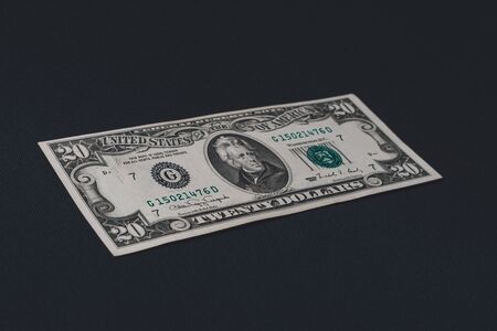 One twenty dollar bill isolated on a black background. 2019の写真素材