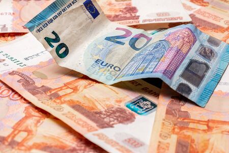 Texture of different international currencies, 20 euros on the background of 5000 rubles. 2019