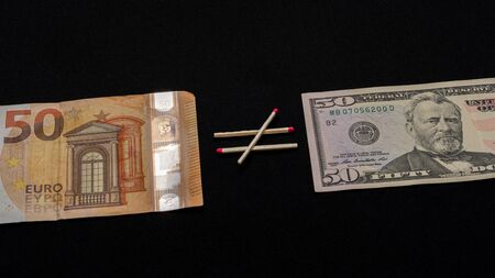 Euro is not equal to dollar, paper money on a black background. 2019の写真素材