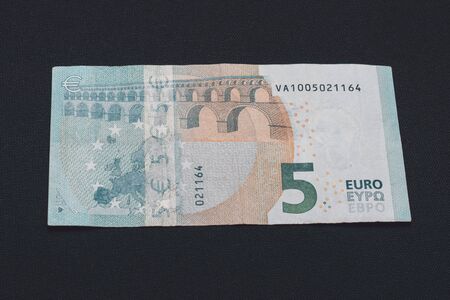 Detail of 5 euro banknote with anti-counterfeiting holograms, Selective focus, black background, one banknote. 2019の写真素材