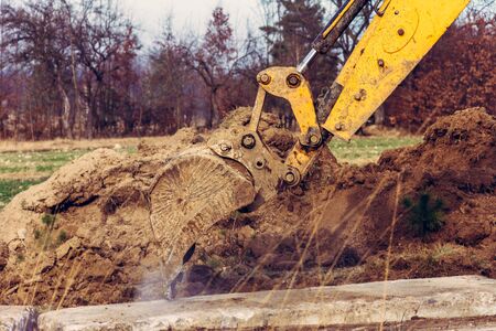 The excavator moves the concrete slabs to set the road in private territory. 2020の写真素材