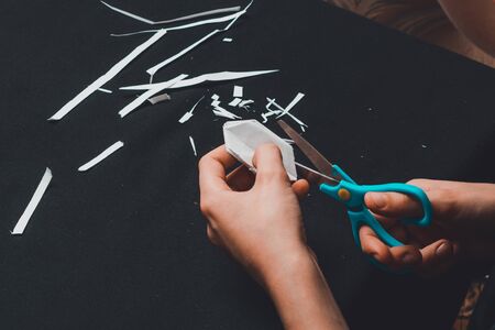 From white paper boy cuts a white square.2020の写真素材