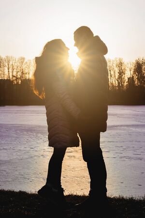 Silhouettes of boyfriend and girlfriend at sunset.2020の写真素材