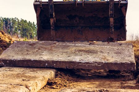 Road on concrete slabs to the gate of a private house in the village.2020