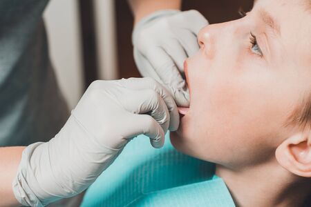 The boy orthodontist makes a fitting for the plate.2020の写真素材