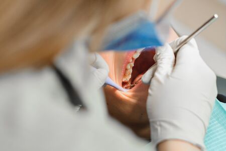 The boy examined by an orthodontist, he opened his mouth wide and the dentist examined his teeth.2020の写真素材