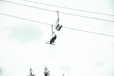 Bukovel, Ukraine February 3, 2019: On the lifts, tourists ascend the mountain peaks in Bukovel,...