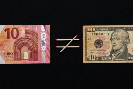 Dollars and euros on a black background, comparing ten euros to ten dollars. 2019の写真素材