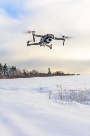 Running drone into the sky, quadcopter on blue sky background.2020の写真素材