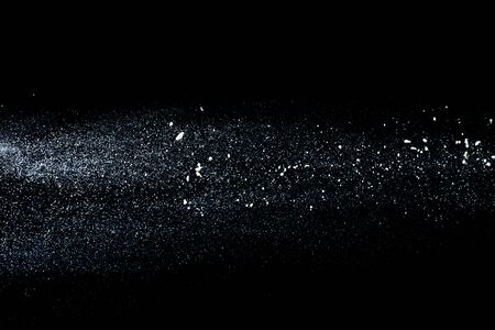 Scattered white flour on black background.2020