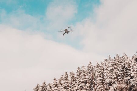 The drone flies in the winter above the forest and shoots landscape videos.2020の写真素材