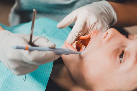 The boy in the dental office, examining new teeth and treating defective ones.2020の写真素材