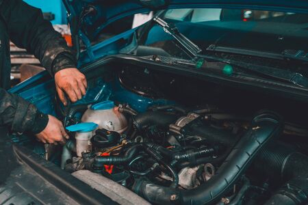 the master repairs the engine in the car service during a malfunction 2020の写真素材