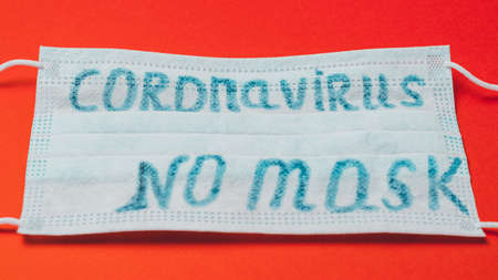 inscription coronavirus on mask, inscription no masks on red background.2020