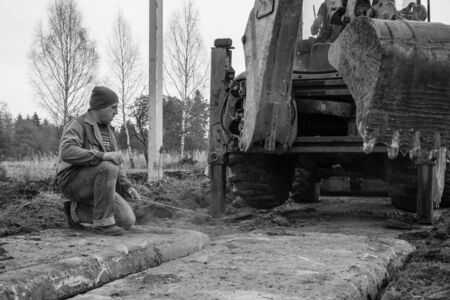 The excavator installs concrete slabs for the road. 2019の写真素材