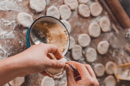 A lean Ukrainian dish, a woman in the kitchen prepares dumplings with potatoes.2020の写真素材