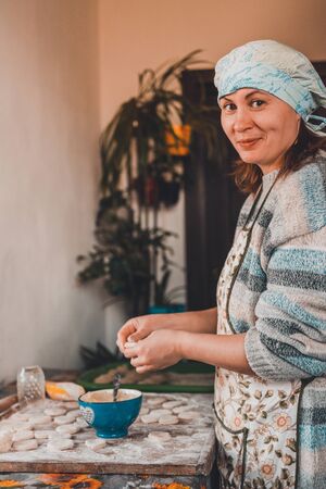 A lean Ukrainian dish, a woman in the kitchen prepares dumplings with potatoes.2020の写真素材