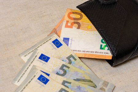 Euro banknotes in leather wallet on light background. 2020