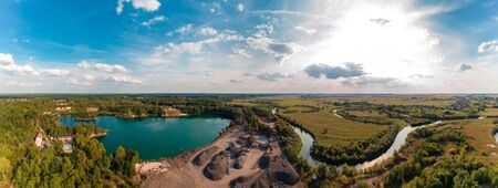 A beautiful panorama of the countryside of a basalt quarry with the rivers and lakes of western Ukraine from a height 2020の写真素材