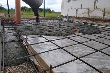Pouring concrete after placing steel reinforcement to make a screed, the photo shows sewer pipes. 2019の写真素材