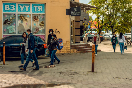 Restoration of life after quarantine. People in masks during a coronavirus pandemic. Halytska...