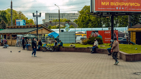 Restoration of life after quarantine. People in masks during a coronavirus pandemic. Market Square. Ivano-Frankivsk, Ukraine - May 25 2020.のeditorial素材