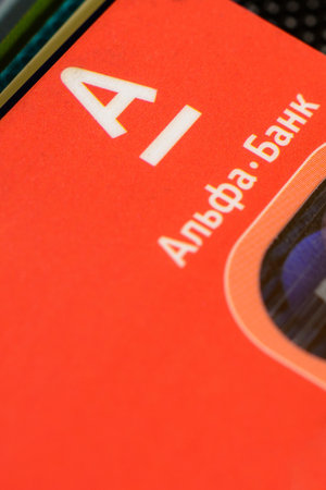 Lviv, Ukraine - 26 April 2019 : Stack of colorful credit cards of the Ukrainian bank titled AlfaBank...