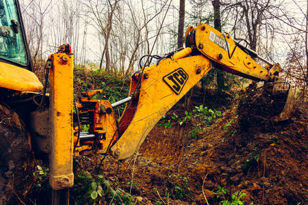 Trostyanets, Ukraine December 20, 2019: excavator digs soil in a village in a private yard.2020のeditorial素材