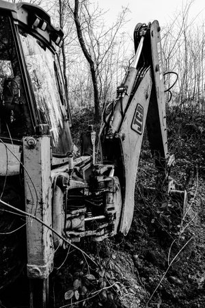 Trostyanets, Ukraine December 20, 2019: excavator digs soil in pond forest.2020のeditorial素材