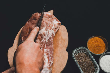 The butcher cuts the pork, marinates the raw meat and cook the kebab.の写真素材