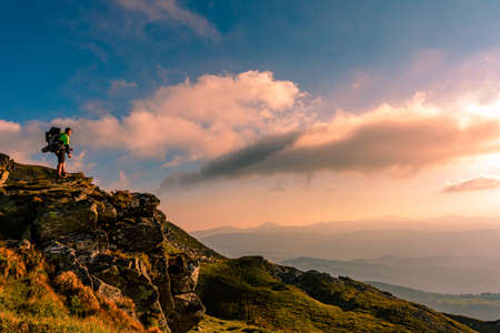A little boy standing on a large rocky rock admires the landscape of the Carpathians, the top of Mount Pip Ivan Chornohirsky. 2020の写真素材