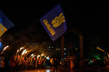 Dolyna, Ukraine: October 14, 2020 peaceful action of the political party Svoboda. 2021 Nationalist flag close up on night street.のeditorial素材