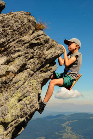 A 11-year-old boy is studying mountaineering in the Carpathians, a boy climbs to the top of a rocky rock alone without the help of an instructor and parents. 2020の写真素材