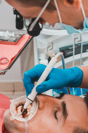 Dental clinic, private practice, the dentist uses binoculars for the best result and work, the...